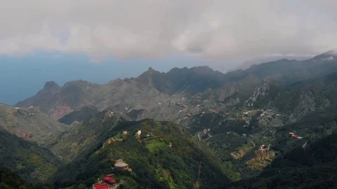 Strong wind high in the mountains, aerial view of the valley and small villages Stock Footage 111308439