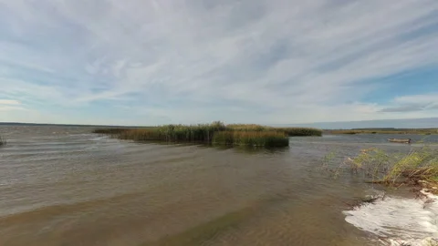 Strong wind on the lake. Time lapse. The camcorder rotates smoothly from left to Stock Footage 97105426