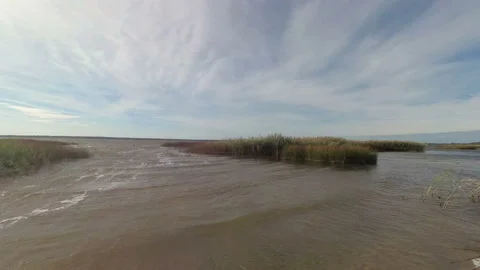 Strong wind on the lake. Time lapse. The camcorder rotates smoothly from left to Stock Footage 97105433