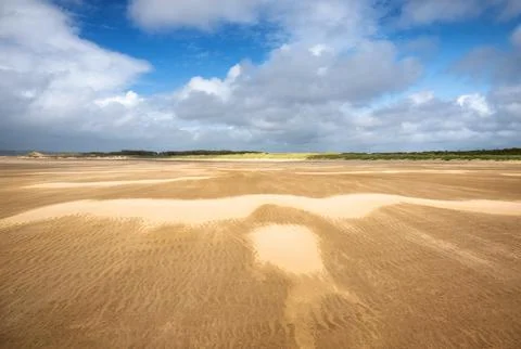 Strong wind shapes sand patterns across Whiteford Sands in Swansea, Wales Stock Photos
