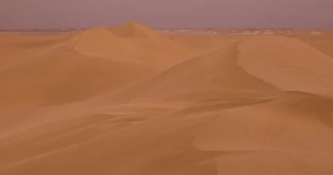 Strong wind at sunset over the sand dunes in the desert. Sandstorm in the Desert Stock Footage 168175385