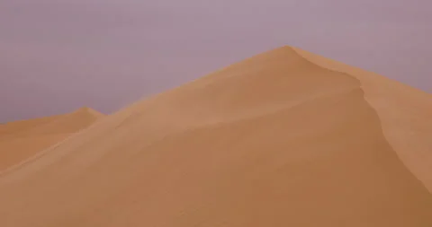 Strong wind at sunset over the sand dunes in the desert. Sandstorm in the Desert Stock Footage 168176476