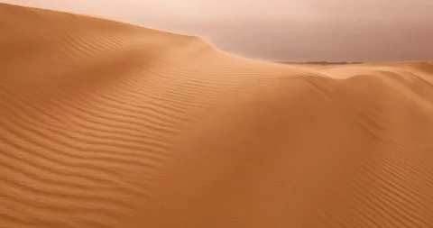 Strong wind at sunset over the sand dunes in the desert. Sandstorm in the Desert Stock Footage 168178691