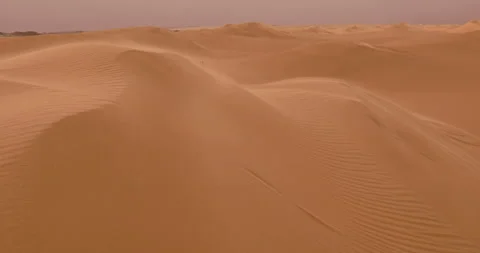 Strong wind at sunset over the sand dunes in the desert. Sandstorm in the Desert Stock Footage 168182409