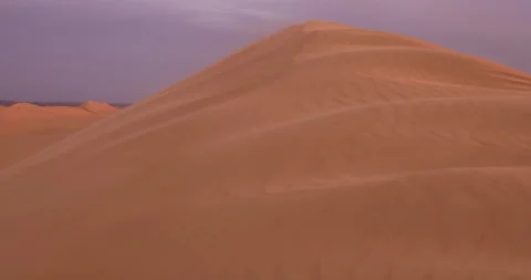 Strong wind at sunset over the sand dunes in the desert. Sandstorm in the Desert Stock Footage 195991610