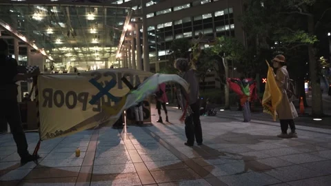 Strong wind sways large protest flags against the Tokyo Olympics - 4K Stock Footage 154898292