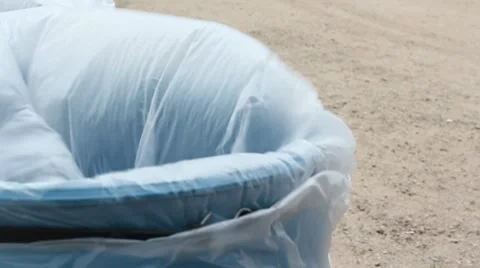 Strong winds blow on trash can Stock Footage 7738088