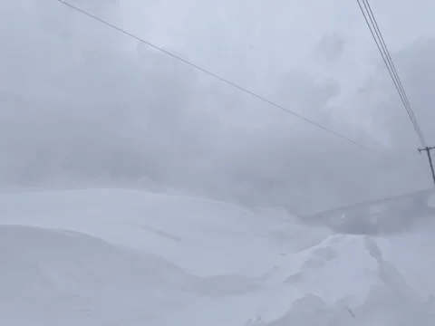 Strong winds blowing drifting snow over snowdrift winter landscape Stock Footage 283816664