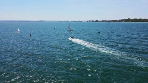 Strong Winds Small Boat Drone Aerial Follow FPV Shot Orbit Summer Sports Seaside Stock Footage 289577780