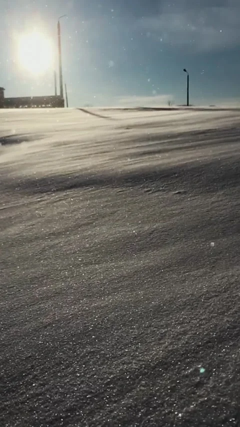Strong winter wind blows snowflakes down a hill Stock Footage 165238761