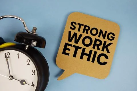 Strong Work Ethic text with alarm clock on blue background Stock Photos