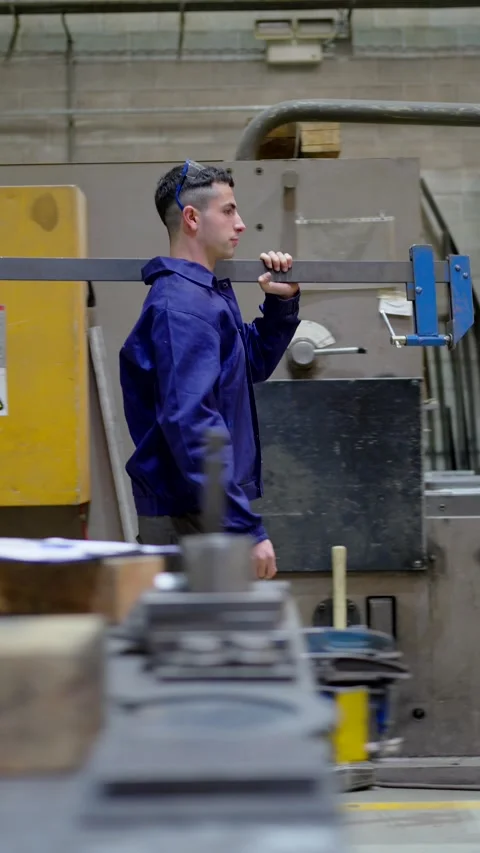 Strong worker walking while carrying big clamp 스톡 동영상 266070561