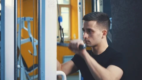 Strong young bodybuilder. Spotted man pumping muscle. Bodybuilding training Video stock 115845510