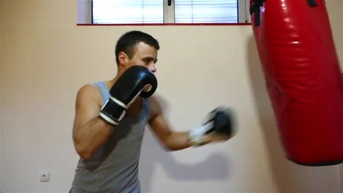 Strong young boxer hitting the boxing bag. Stock Footage 83627579