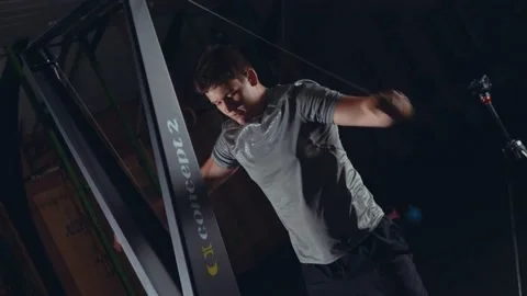 Strong young male doing crossfitt ski/skierg machine exercise Video stock 131225317