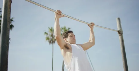 Strong young man performing pull ups on bar Stock Footage 106198197