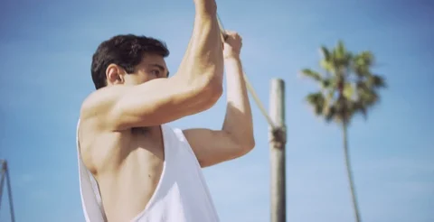 Strong young man performing pull ups on bar Stock Footage 106234921