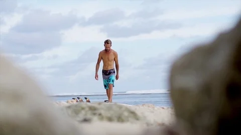 Strong young surf man walking at the beach with a surfboard. Bali, Indonesia Video stock 71537050