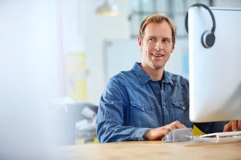 Struck by an idea. Portrait of a designer at work on a computer in an office. Stock Photos