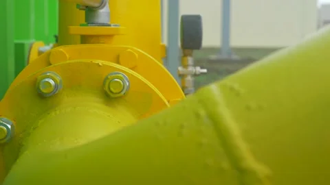 Structural bolt with hex nut and washer connect yellow pipes Stock Footage 179759202