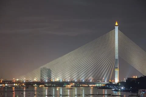 Structural of bridge across river againts night time sky Stock Photos