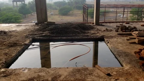 Structural columns and a partially constructed building, with a view of Stock Footage 289545318