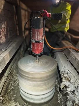 Structural concrete core drilling in attic construction environment. Foto stock