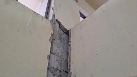 Structural crack between wall and concrete column of building Stock Photos