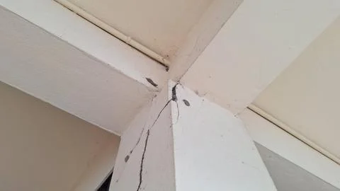 Structural crack on concrete pillar and ceiling beam corner Stock Photos