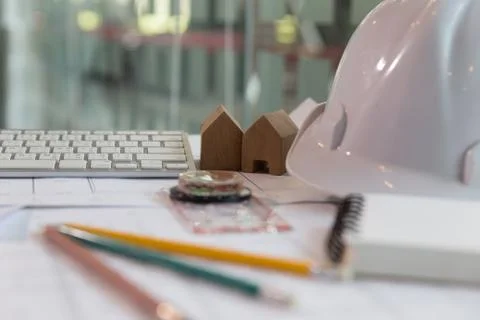 Structural engineer and architect desk with safety helmet, blueprint and mo.. Stock Photos