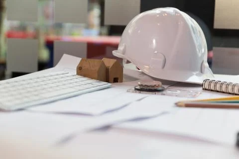 Structural engineer and architect desk with safety helmet, blueprint and mo.. Fotos de archivo