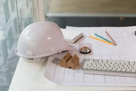 Structural engineer and architect desk with safety helmet, blueprint and mo.. Fotos de archivo