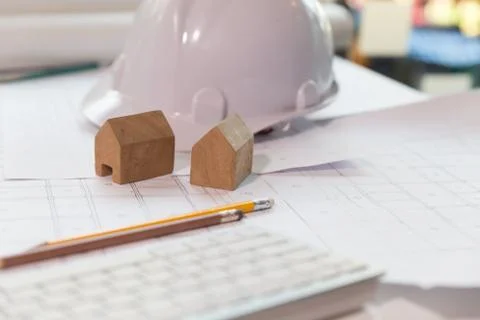 Structural engineer and architect desk with safety helmet, blueprint and mo.. Fotos de archivo