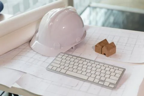 Structural engineer and architect desk with safety helmet, blueprint and mo.. Stock Photos