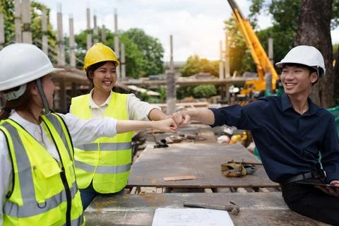 Structural engineer and architect discussing and working with blueprints at the Stock Photos