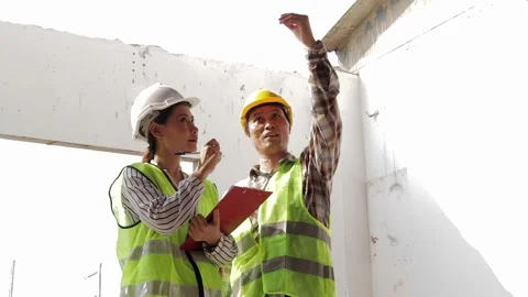 Structural engineers and Asian construction foreman are at the construction Stock Footage 201666185
