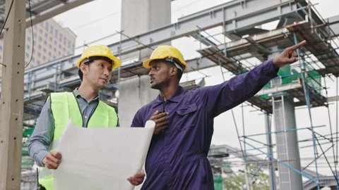 Structural engineers and construction workers are holding blueprints inspecting  Stock Footage 224508857
