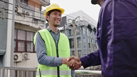 Structural engineers and construction workers are holding blueprints inspecting  Stock Footage 225290135