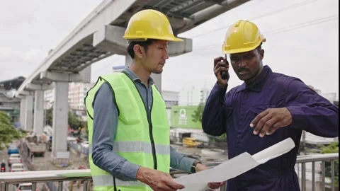 Structural engineers and construction workers are holding blueprints inspecting  Stock Footage 225290226