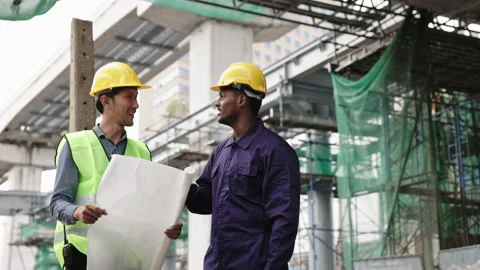 Structural engineers and construction workers are holding blueprints inspecting  Stock Footage 228391390