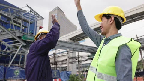 Structural engineers and construction workers are holding blueprints inspecting  Stock Footage 228391420