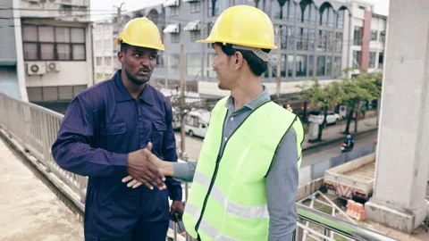 Structural engineers and construction workers are holding blueprints inspecting  Video stock 235604446