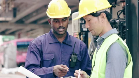 Structural engineers and construction workers are holding blueprints inspecting  Video stock 235607794