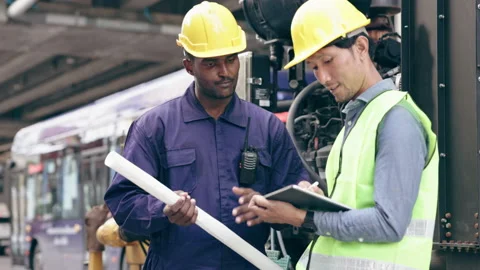 Structural engineers and construction workers are holding blueprints inspecting  Stock Footage 235886947