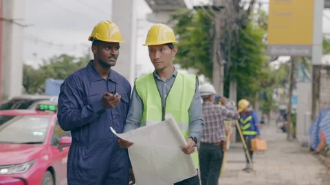 Structural engineers and construction workers are holding blueprints inspecting  Stock Footage 241424723