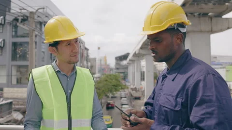 Structural engineers and construction workers are holding blueprints inspecting  Stock Footage 241426044