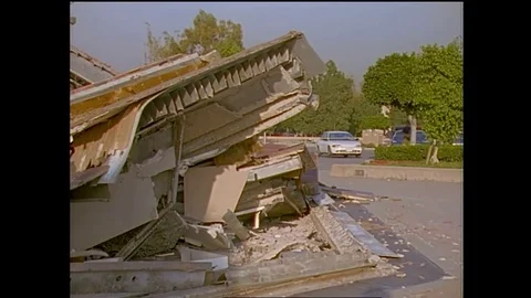 Structural engineers study a collapsed shopping center during the 1994 Stock Footage 74837090