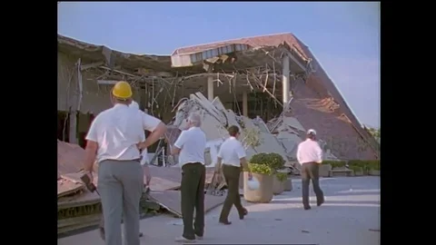 Structural engineers study a collapsed shopping center during the 1994 Stock Footage 74837436
