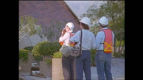 Structural engineers study a collapsed shopping center during the 1994 Stock Footage 74838569