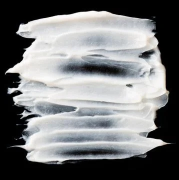 Structural plaster white on a black background. White Cream. paint smear Stock Photos